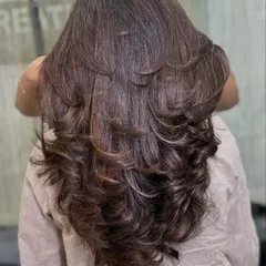 The back view shows the full effect of the layered haircut and multi-tonal brown color. Each layer is defined, creating beautiful texture and the illusion of thicker, fuller hair.