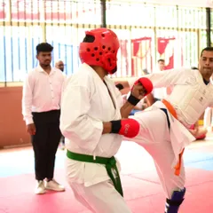 An adult student lands a controlled kick during a tournament bout. We offer competitive opportunities for all age groups, fostering a spirit of continuous improvement.