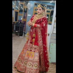 Another view of this stunning red bridal rental lehenga, showing the full flare and intricate work on the skirt. It’s a regal choice that ensures you are the center of attention.