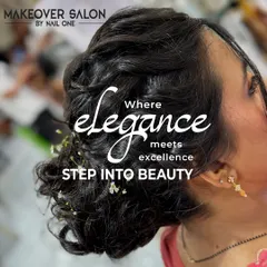 This image captures the essence of our styling philosophy: "Where Elegance meets excellence." We created a sophisticated updo with delicate floral accents, perfect for a wedding or formal event.