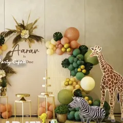 This modern and chic safari theme for Aarav's first birthday used a neutral color palette with pampas grass and gold accents. The life-sized giraffe and zebra props added a 'wow' factor to the decor.