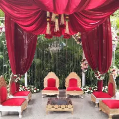 A closer view of our red velvet mandap design, highlighting the ornate thrones and the detailed floral work that frames the sacred space. Every element is chosen to contribute to a grand and memorable ceremony.