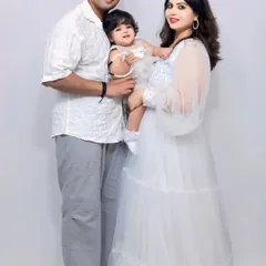 A beautiful family portrait. The mother is wearing my white sequin flare gown, which we've coordinated with a matching white dress for her daughter.
