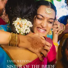 An emotional hug between sisters at a traditional Tamil wedding. We styled the sister of the bride in a vibrant Kanjeevaram saree with fresh flowers in her hair, a classic South Indian bridesmaid look.
