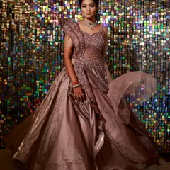 For the bride who wants to make a grand entrance at her sangeet. This full-length shot shows a dramatic, flowing gown with intricate beadwork, paired with an elegant updo and sparkling diamond jewellery.