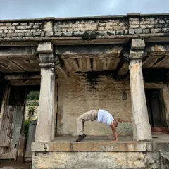 In the quiet of an old stone temple, I practice Chakrasana, the wheel pose. These moments remind me to stay humble, keep learning, and find inspiration in the history and nature around us.