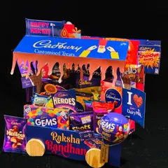 This Cadbury-themed Rakhi hamper is a chocolate lover's dream. Shaped like a delivery truck, it's overflowing with a variety of Cadbury chocolates, from Dairy Milk to Gems, perfect for a sweet-toothed sibling.