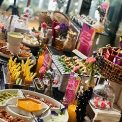 We created this fun and interactive snack table for a client's karaoke night. It features a unique Dorito’s DIY bar, sushi, dim sum, a Lebanese food board, and a gooey cheese fondue station for a truly memorable evening.
