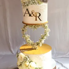 I love creating dramatic, multi-tiered cakes for big celebrations. This engagement cake features a floating heart made of delicate baby's breath, connecting two tiers for a truly magical effect. It's a perfect centerpiece for a modern romance.