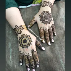 This mandala design is a showstopper. The bold center and delicate finger details create a perfect balance.