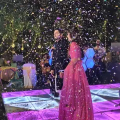 A couple stands on stage under a shower of confetti. We love creating these picture-perfect, celebratory moments for our clients.