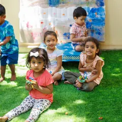 A group of friends proudly holding their creations after a fun session. The social aspect of my workshops is just as important as the activities themselves, helping children build friendships and learn to play together.