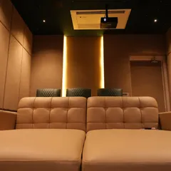 The view from the daybed, looking towards the back of the room. The warm, indirect lighting and padded walls create a cozy and acoustically balanced environment.