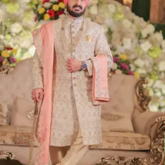 A classic portrait of the groom in his elegant sherwani, looking poised and ready for the ceremony.