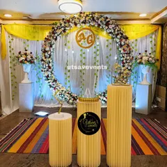 An elegant engagement stage centered around a large ring made of fresh flowers. The custom gold monogram inside the ring adds a personalized touch for the couple.
