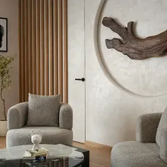 The son's bedroom in The House of Dancing Screens uses an earthy color scheme. Soft curves, textured furnishings, and a custom wooden art piece give this room a sophisticated and personal charm.