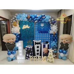 We brought the popular 'Boss Baby' to life for a first birthday with this fun setup. It includes character cutouts, a custom backdrop, and themed plinths, all in a classic blue and silver color scheme.