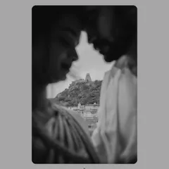 An artistic black and white shot with the Melkote temple in the background. The selective focus creates a dreamy, intimate portrait while still honoring the sense of place.