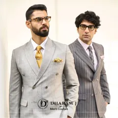 Two examples of my double-breasted suits. On the left, a light grey suit with a gold tie, and on the right, a pinstripe suit. Both are tailored to perfection for a sharp, professional look.