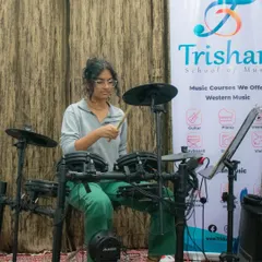 A student fully engaged during her drum performance at our HSR open mic. We provide training on full electronic drum kits.