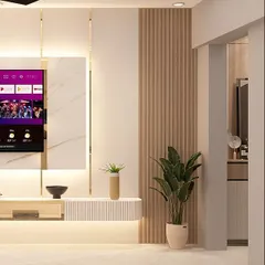 This TV unit design shines with its minimalist luxury. Fluted wood panels, marble accents, and subtle gold trim create a calm and sophisticated focal point.