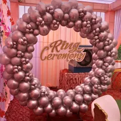 A popular choice for ring ceremonies, this backdrop features a full circular frame covered in metallic silver balloons. A custom 'Ring Ceremony' sign is placed in the center to mark the special occasion.