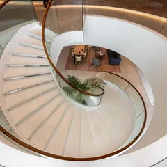 The sculptural spiral staircase at the Asian Paints headquarters serves as a central connecting element, embodying the brand's commitment to design and innovation. It is more than a means of circulation; it is a statement piece that anchors the executive floors.