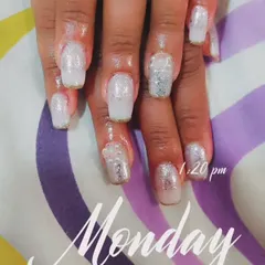 A full set of white glitter nail extensions with a hint of gold at the tips for a frosty, sparkling look.
