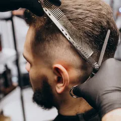 The foundation of a great men's haircut lies in technique. This is a glimpse of our scissor-over-comb method, a fundamental skill our barbers use to create seamless fades and structured styles.