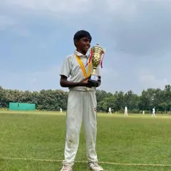 One of our U12 champions, smiling as he holds his trophy after a successful tournament.
