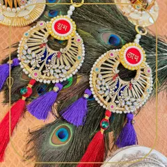 This peacock-themed Shubh Laabh is a true statement piece. The intricate thread work, sparkling stones, and vibrant tassels come together against a backdrop of real peacock feathers, creating a luxurious decor item for your door.