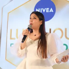 A candid, close-up shot during the Nivea launch event, showing my focus and command as a product launch presenter.