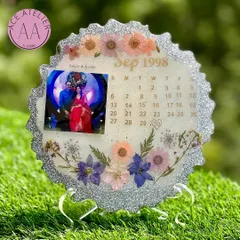 A sparkling silver-themed calendar frame celebrating a September 1998 wedding. The glittery border and delicate pastel flowers make this a perfect silver jubilee anniversary gift.