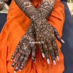 This design showcases a dense floral pattern on the palms, complemented by bands of geometric and traditional figures on the arms.