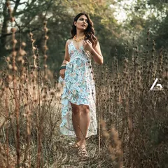 I often direct models to interact with their environment to make the photos feel more dynamic. In this shot, the model walks through a field of tall grass, which adds texture and a sense of place to this lifestyle fashion image.