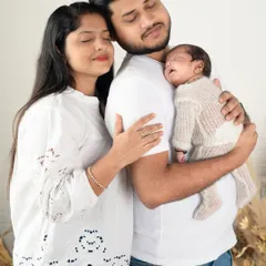 A moment of pure peace and love. The family huddles together, eyes closed, just soaking in the feeling of being together with their new baby.