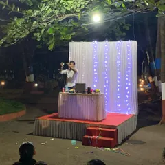 Here I am in the middle of a performance, set against a simple yet elegant stage setup. My act is adaptable to any venue, whether it's a large auditorium or an outdoor event space.