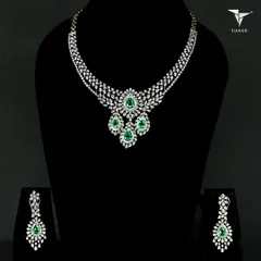 This emerald and diamond set tells a story of grace and boldness. The pear-shaped emerald drops are surrounded by a halo of brilliant diamonds, ensuring you are the unforgettable moment.