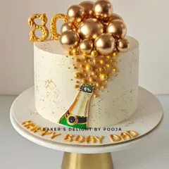 Cheers to 80 amazing years! This elegant champagne bottle cake features a hand-painted bottle with golden bubbles cascading down the side, perfect for a milestone celebration.