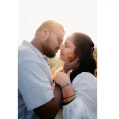 A close-up shot using the sun's flare to create a dreamy, romantic effect. It highlights the couple's connection in a soft, beautiful light.