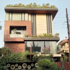 A full view of a modern villa in Noida where I designed and installed integrated greenery on the ground floor, balconies, and a full rooftop garden.