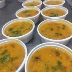 Portions of freshly made dal, ready to be packed for corporate orders. We prepare all our food in bulk while maintaining authentic, home-style taste.