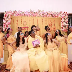 Another lively group photo from the Haldi ceremony. Capturing these candid, energetic moments is key to creating a memorable wedding album.