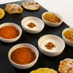 Our bread bar brings the warmth of the tandoor to your table. Here, an assortment of our breads is served with our signature black dal, chutneys, and house-made pickles. Just tear, dip, and repeat.