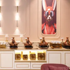 Our premium buffet station, ready to serve delicious global cuisine to guests. The stylish setup and artistic wall decor complement the five-star dining experience we provide.