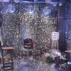 Another angle of the full shimmer wall room, showing the reflective surfaces and lighting. This type of all-encompassing decor provides a unique and highly photogenic setting for any celebration.