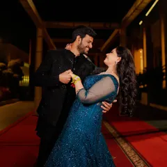 A candid moment on the red carpet during the sangeet night. The movement and genuine smiles create a dynamic and joyful portrait that captures the energy of the celebration.