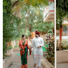 A candid shot of the couple walking together, showcasing their beautiful wedding outfits and the natural, relaxed environment of their celebration.
