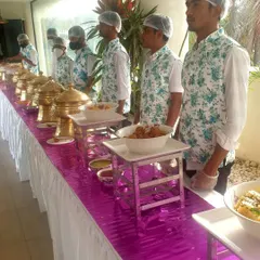 A full view of the uniformed service team along the buffet line. This demonstrates the organized and disciplined approach I bring to managing food service for corporate clients.