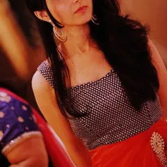 For this party look, I designed a modern ensemble featuring a sleeveless sequined crop top paired with a vibrant orange organza skirt. This style is perfect for a sangeet or cocktail function where you want to dance the night away.